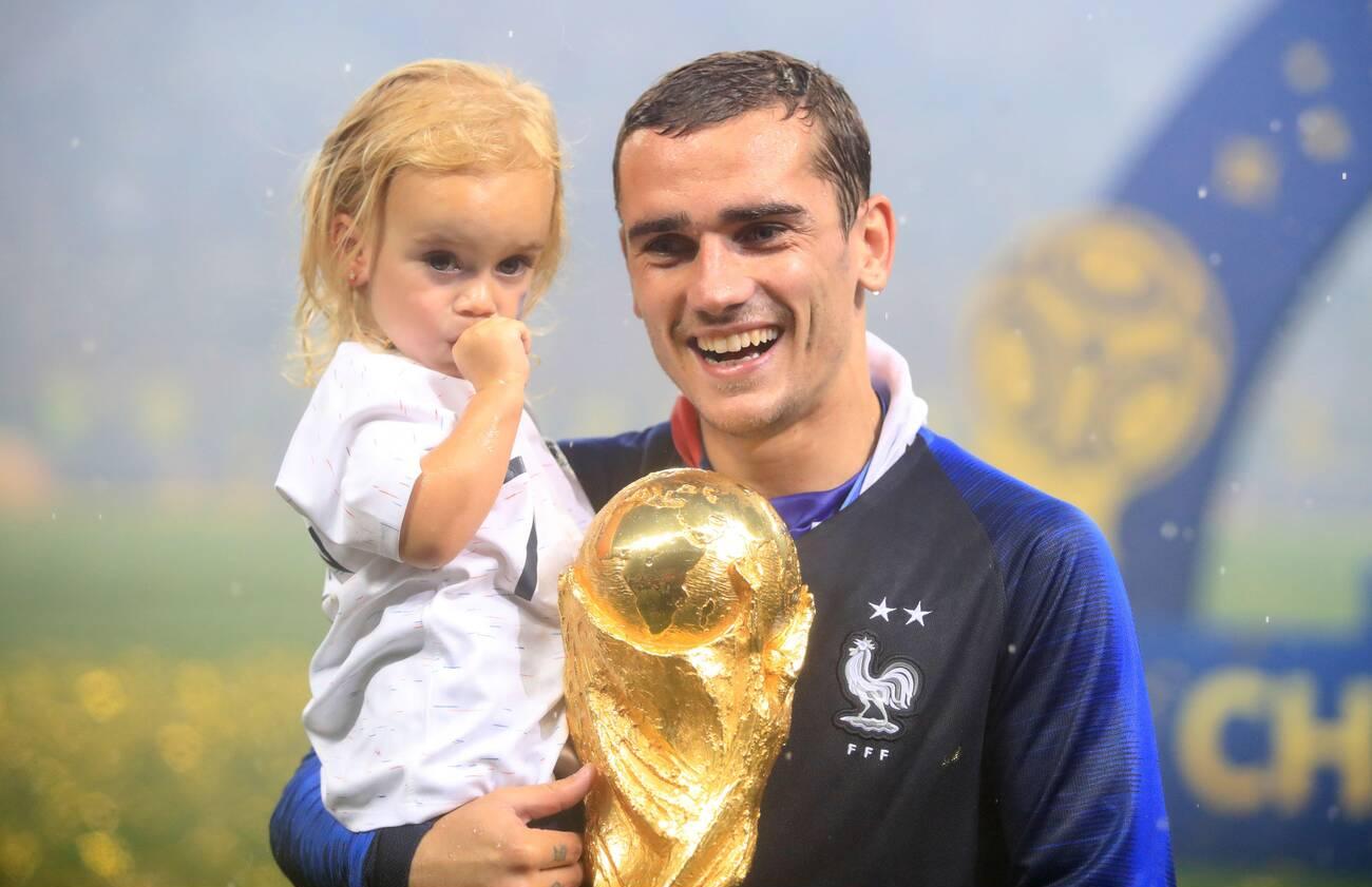 France's Antoine Griezmann celebrates with daughter Mia Griezmann and the trophy after France win the FIFA World Cup 2018